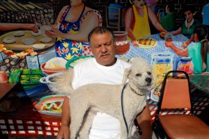 A man and his dog at the Paraiso Cafe in the Mission