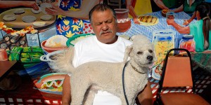 A man and his dog at the Paraiso Cafe in the Mission