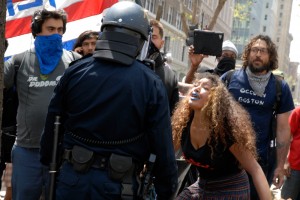 protestor with blue lips confronts policeman